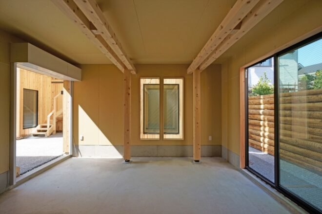 room with light floors, tan walls and large sliding glass doors