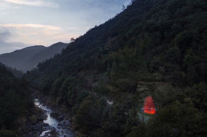 aerial view of red triangular structure beside a stream