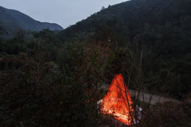 red triangular pavilion facing mountains