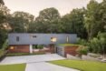 gray and wood home with green roof