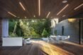 outdoor patio with white furnishings and recessed lighting