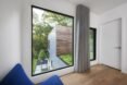 white room with large glass windows