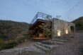 square cabin clad in natural stone