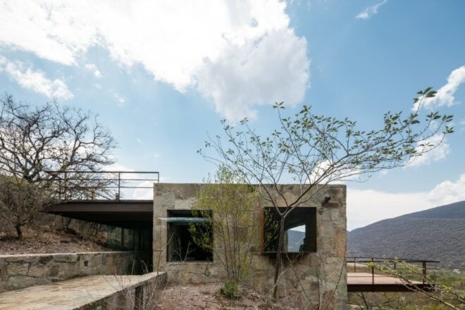 square cabin clad in natural stone