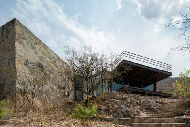 cabin with glass facade and cantilevered rooftop terrace