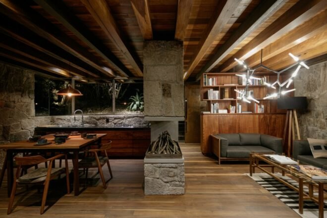 wood and stone cabin interior with central fireplace