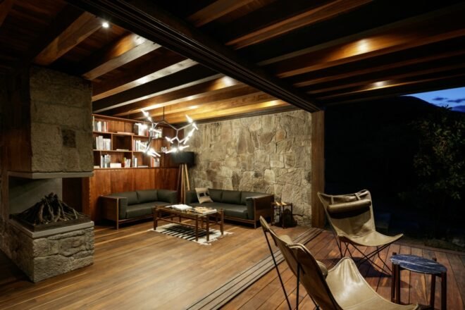 black leather couch and sofa in a wood and stone cabin