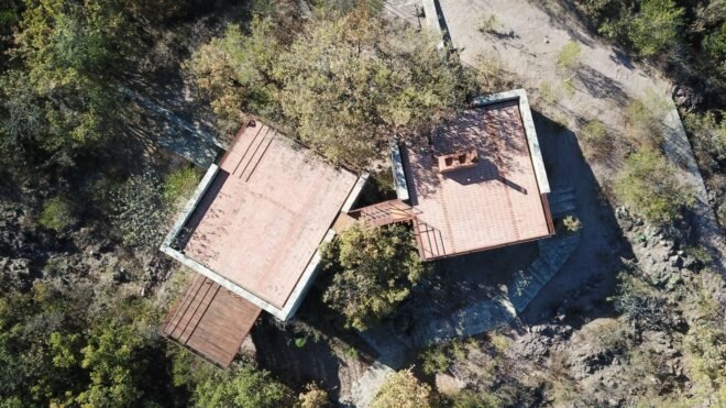 aerial shot of two square cabins