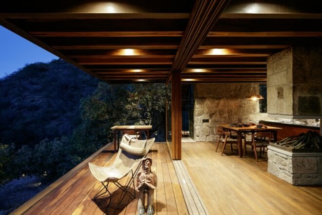 cabin interior with wood ceilings and floors and several seating spots