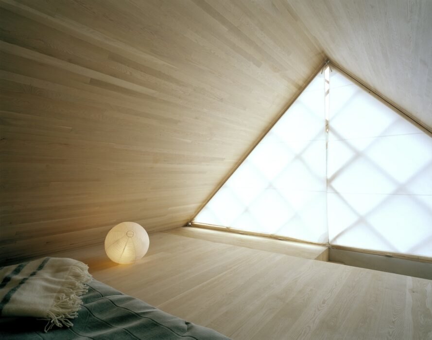 interior bedroom area with geometrical designed windows and walls