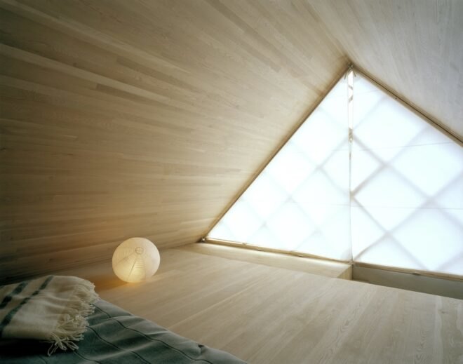 interior bedroom area with geometrical designed windows and walls