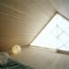 interior bedroom area with geometrical designed windows and walls