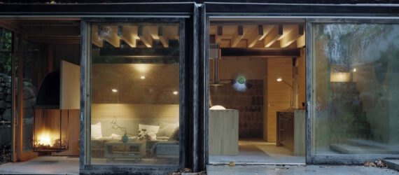wooden cabin in Swedish countryside surrounded by greenery