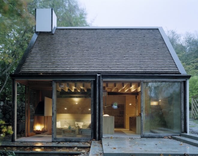 wooden cabin in Swedish countryside surrounded by greenery