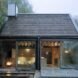 wooden cabin in Swedish countryside surrounded by greenery