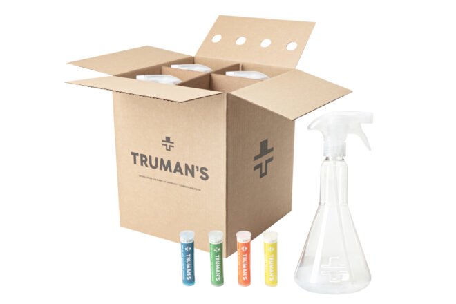 cardboard box with plastic spray bottles and colorful cleaning cartridge refills