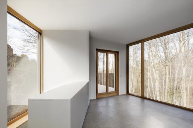 interior of home with white walls and large windows