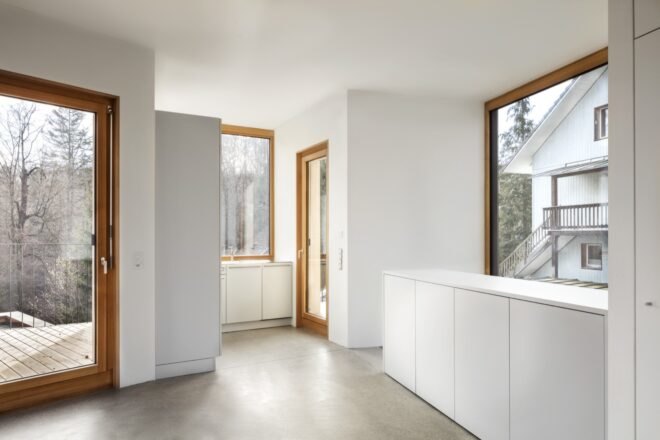 interior of home with white walls and large windows