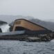 wood and gray building built partially underwater