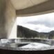 round hot tub on deck facing mountainous landscape
