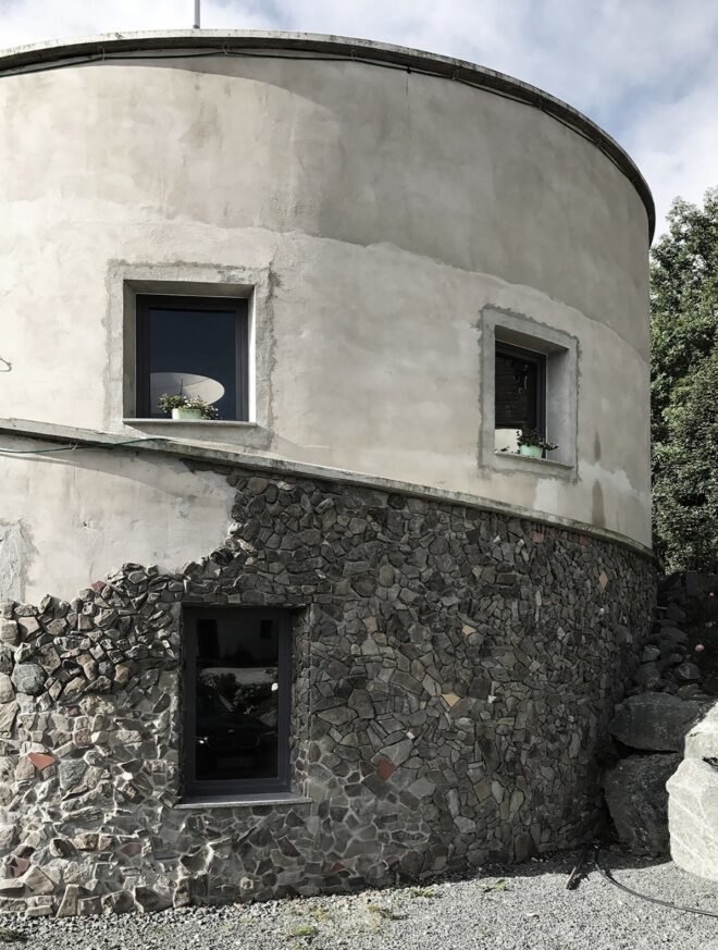 white round building with partial stone facade