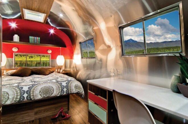 a bedroom with red accent wall