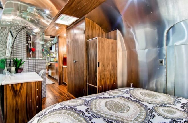 a bedroom in an Airstream with wooden closets