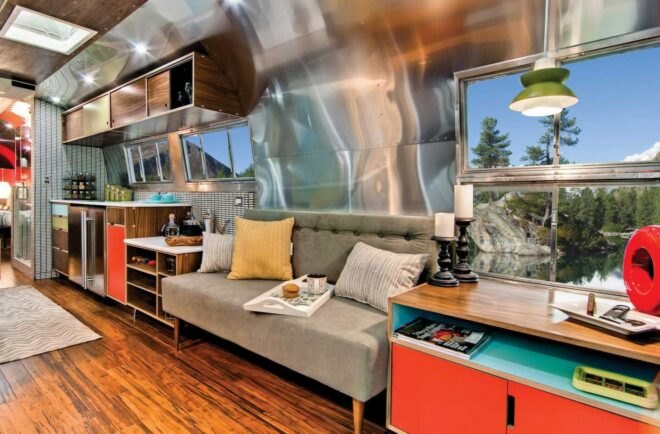 Airstream interior with aluminum walls and a gray sofa