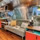 Airstream interior with aluminum walls and a gray sofa