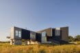 modern home sitting above expansive marshland