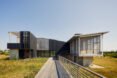 long black home elevated above land