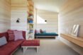 living area with light wood walls and various sofas