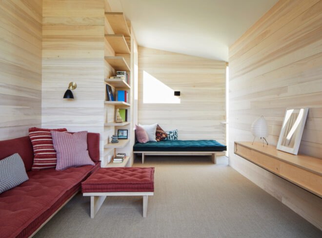 living area with light wood walls and various sofas