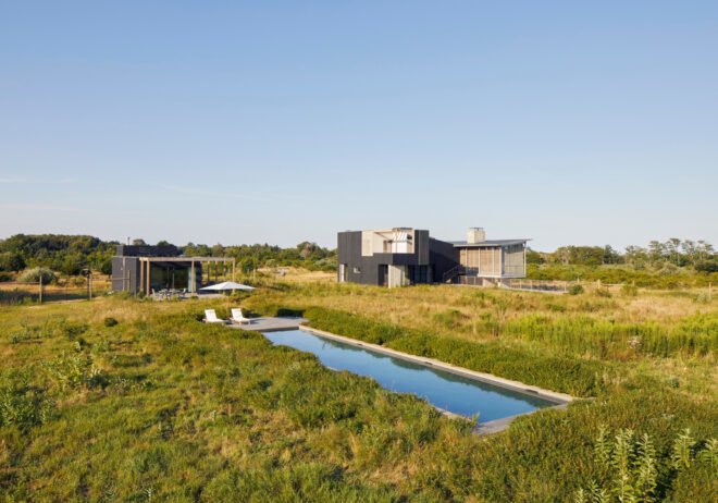 large pool surrounded by expansive green fields