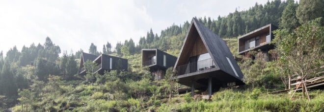 black cabins on a hillside