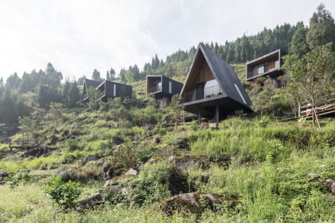 black cabins on a hillside