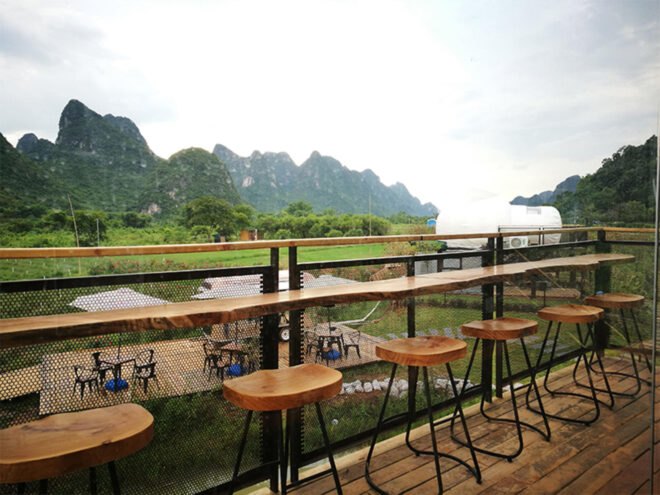outdoor seating area with lots of bar stools
