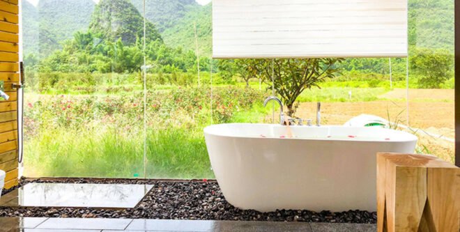 white bathtub next to glass walls