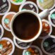 cup of coffee atop unused coffee pods