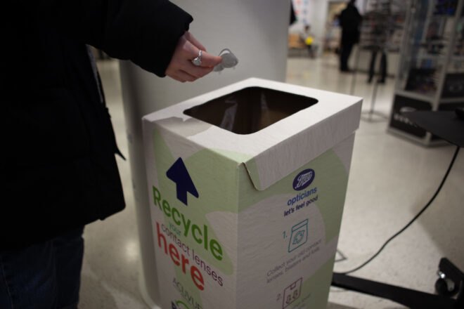 person depositing contacts in special recycling bin