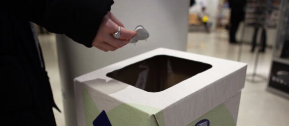 person depositing contacts in special recycling bin