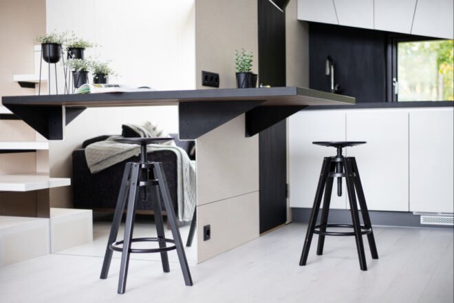 modern living space with white walls and black furnishings