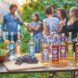 bottles of alcohol on table in foreground with people chatting in background
