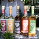 bottles of alcohol with colorful labels on table in a kitchen