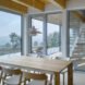 interior of home with wooden table and chairs and wood ceiling with glass doors leading towards wooden staircase
