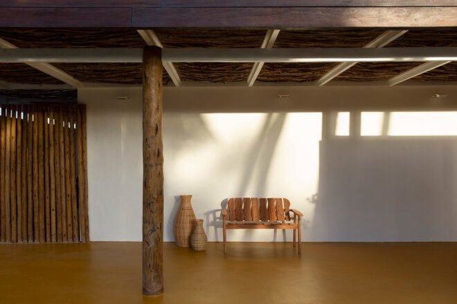 interior of home with white walls ans yellow flooring with a wood chair