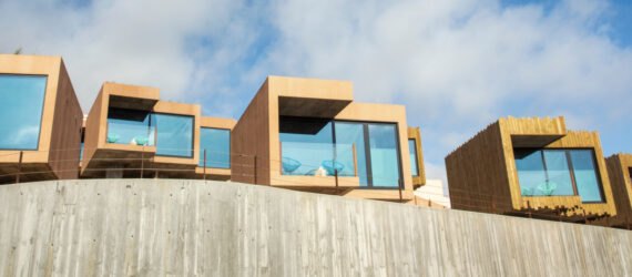 series of wooden structures with glass facades