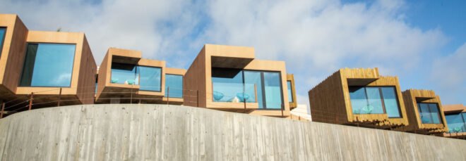 series of wooden structures with glass facades