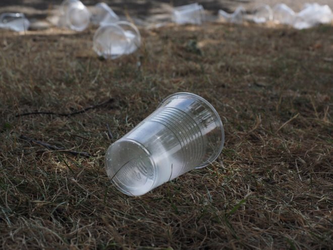 clear plastic cup lying on the ground