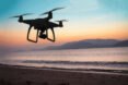 drone flying over ocean during sunset